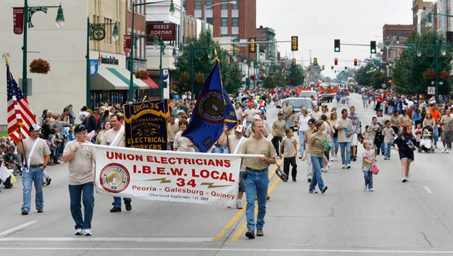 Members and families of International Brotherhood of Electrical Workers Local 34 prepare to make the turn from Main Street onto Cherry Street during the Labor Day parade Monday morning in downtown Galesburg.