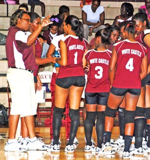 WCHS COACH...White Castle High Coach Tammy Washington-Pierce, left, gives instructions to her Lady Bulldogs during last week’s volleyball victory over Plaquemine. (Photo by Lyn Pierce)