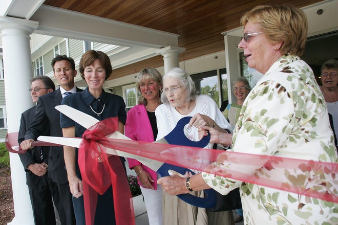 Dottie Goddard, far right, from the Franklin Federated Church helps Ruth Emmons of Franklin cut the ribbon in front of the new Eaton Place senior housing building Sept. 7 while State Sen. Karen Spilka, D-Ashland, next to Emmons, Sue McCann, of Community Builders Inc., state Rep. Jim Vallee, second from left, and Franklin Town Administrator Jeffrey Nutting, far left, all look on during the ceremony. Goddard was instrumental in obtaining the land for the building and naming the building.