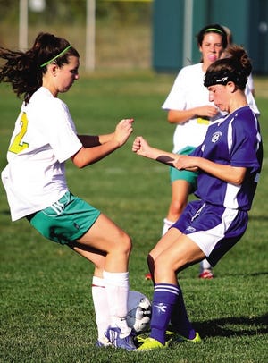 Winnacunnet’s Kara Martin, right, battles for the ball with Bishop Guertin’s Jackie Geisler during Tuesday’s Division I girls soccer game.