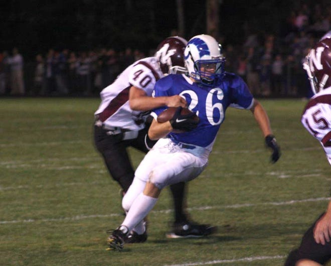 Kennebunk running back Jason Small (26) is slowed down by Noble defender Joe Thyng following a pass reception in the first half of Friday night's game at Kennebunk.
