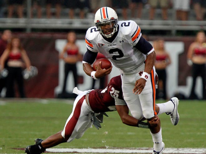 Auburn quarterback Cameron Newton is tackled by Mississippi State cornerback Corey Broomfield in the first quarter of Thursday’s game in Starkville, Miss.