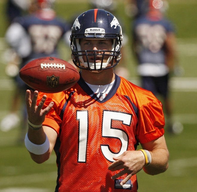 Denver Broncos quarterback Tim Tebow juggles a football during the team's training camp.
