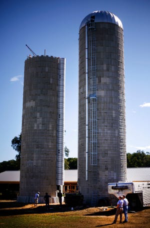 Amish workers from Lancaster, Pa., erect two grain silos at Hornstra Farm in Norwell on Thursday, Sept. 9, 2010.