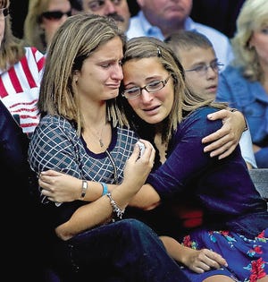 Sisters Chelsea and Devon Rodak embrace during a ceremony in Mantua Township, N.J., Saturday, in honor of the memory of victims of the World Trade Center attacks in 2001. The Rodaks lost their father, John Rodak, during the attacks.