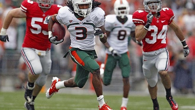 Glades Central grad Travis Benjamin (3) races past Ohio State's defenders for a long punt return touchdown on Sept. 11, 2010.