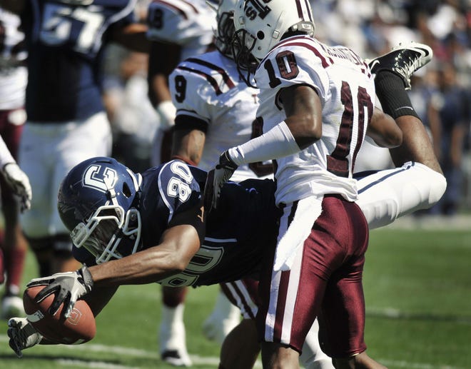 Connecticut's Michael Smith (80) scores a touchdown against Texas Southern's De'Markus Washington (10) during the first half of an NCAA college football game in East Hartford, Conn., Saturday, Sept. 11, 2010. (AP Photo/Jessica Hill)