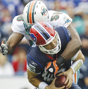 Miami Dolphins' Karlos Dansby (58) sacks Buffalo Bills quarterback Trent Edwards (5) during the first quarter of an NFL football game in Orchard Park, N.Y., Sunday, Sept. 12, 2010. The Dolphins won 15-10.