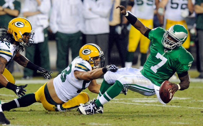 Philadelphia Eagles quarterback Michael Vick (right) is brought down by Green Bay Packers linebacker Frank Zombo (center) and safety Morgan Burnett in the second half of an NFL football game Sunday, Sept. 12, 2010, in Philadelphia. Green Bay won 27-20.