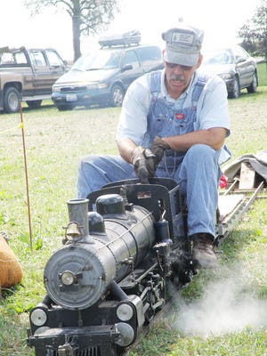 Fred Hansen, the owner and engineer directs his train down the line. This was the engine of the show.