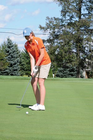 Tecumseh High School girls golfer Murielle Rine putts on the first green during Monday’s Southeastern Conference?match against Ypsilanti Lincoln. Rine carded a 48 to help Tecumseh earn the win.