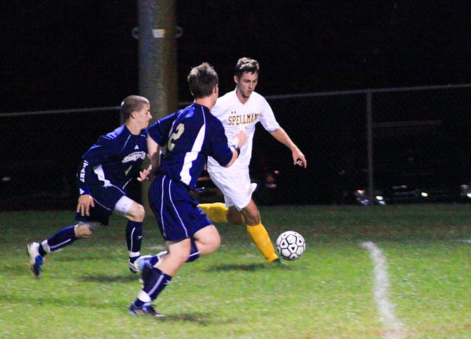 Cardinal Spellman's Chris Conrad, right, tries to break away from St. Mary's defenders during Monday's game.