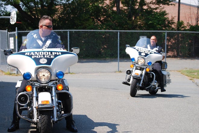 Patrolmen Robert Iskra and Anargyros Siempos show off their new motorcycles. The two bikes are part of the Traffic Safety Unit the Police Department recently enacted.