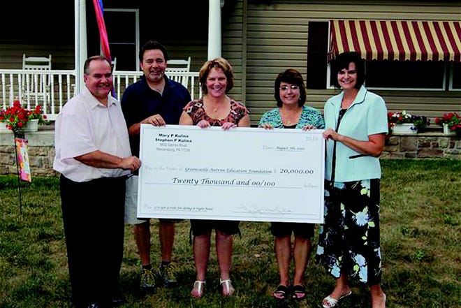 Mary Pat Kulina presented a check to the Greencastle-Antrim Education Foundation for a scholarship in memory of her husband and father. Pictured, from left: Joel Fridgen and Greg Hoover, G-AEF board members, Kulina, Kathy Olivier, G-AEF director, and Kristy Faulkner, G-AEF board member.