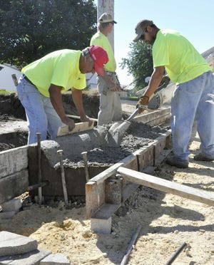 Bob Campos, Ken Gaines and Jesse Berreles, all of Campos Construction, build curbs Tuesday, Sept. 14, 2010, along Elm Avenue and Roosevelt Road in Machesney Park. Reconstruction of Roosevelt Road was the village’s biggest road project this summer and is expected to wrap up by the end of the month.