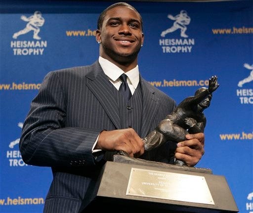 Heisman Trophy winner Reggie Bush of the University of Southern California smiles while posing for photos after a news conference in New York on Dec. 10, 2005. Bush forfeited his Heisman Trophy earlier this week.
