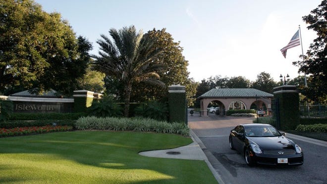 In this Nov. 27, 2009 file photo, a car leaves the gated Isleworth community where Tiger Woods is a resident in Windermere.