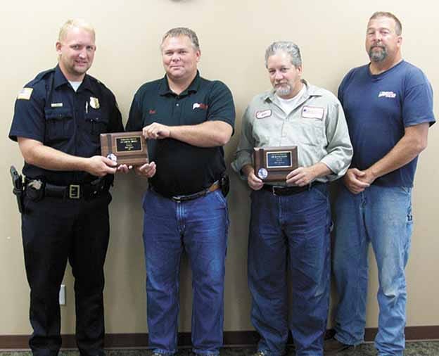 Annawan Police Chief Tim Wise, left, presents plaques of appreciation on behalf of the Village of Annawan, to, continuing to the right, Scot Hyatt, Glen Walters, and Brad Helgason, employees at Patriot Renewable Fuels, LLC., whose swift response recently saved a man’s life.