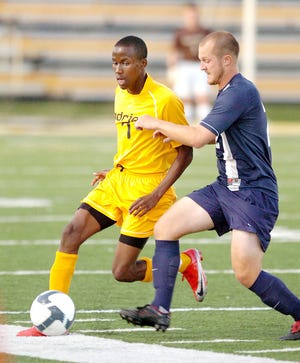 Adrian College forward Cazz Warren tries to dribble past a Siena Heights player during a game last season. Warren hopes to help the Bulldogs improve on last year’s 7-10-3 record.