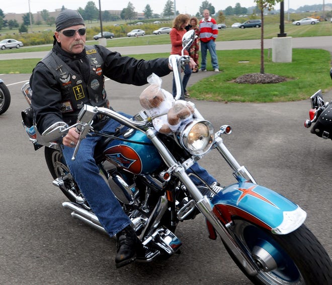 Tim Marquardt of Copley rolls out with Theodore the bear strapped to his handle bars on his way to Akron with other members of the Faith Family Church Iron Harvest Motorcycle Ministry who had joined in for the 15th annual Children's Caravan to benefit Akron Children's Hospital. The event has been nicknamed the "Teddy Bear Run" for the thousands of stuff bears the bikers deliver.