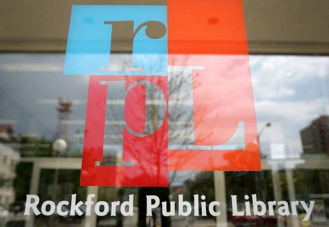 Downtown is reflected in the front window of the Rockford Public Library Main Branch on Friday, Aug. 13, 2010.