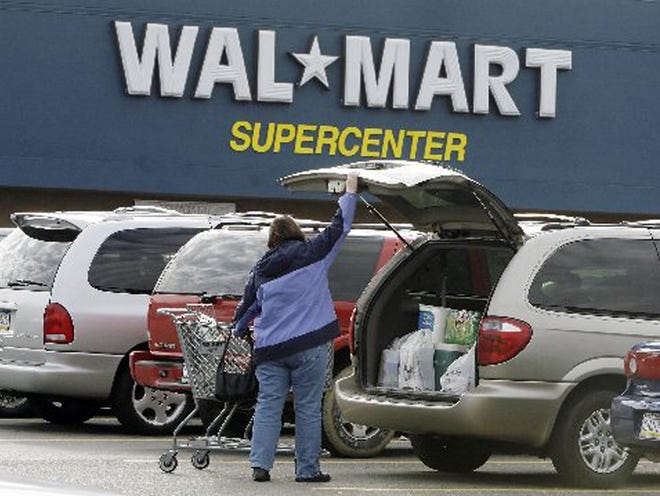 A shopper at a Walmart in North Fayette, Pa., loads her purchases into her car (2007).