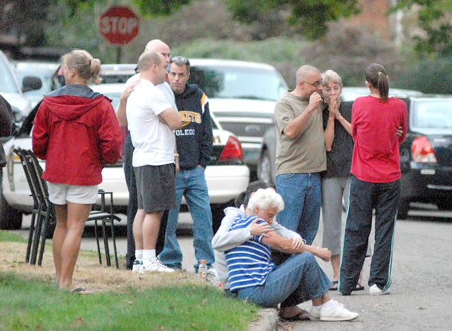 Family and friends mourn the scene of Sunday's double homicide-suicide on Oxford Avenue Northeast.