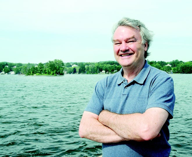 Author and veteran journalist James Herbert Smith has written a novel inspired by Squaw Island and Canandaigua Lake. Here he is on the City Pier with the island in the background.