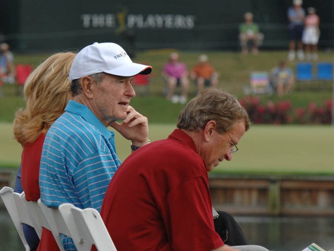 Former President George Bush (middle in blue), shown here watching golf at No. 17 at the TPC Sawgrass Players Stadium Course in 2008 with PGA Tour Commissioner Tim Finchem (right), will be inducted into the World Golf Hall of Fame in 2011.