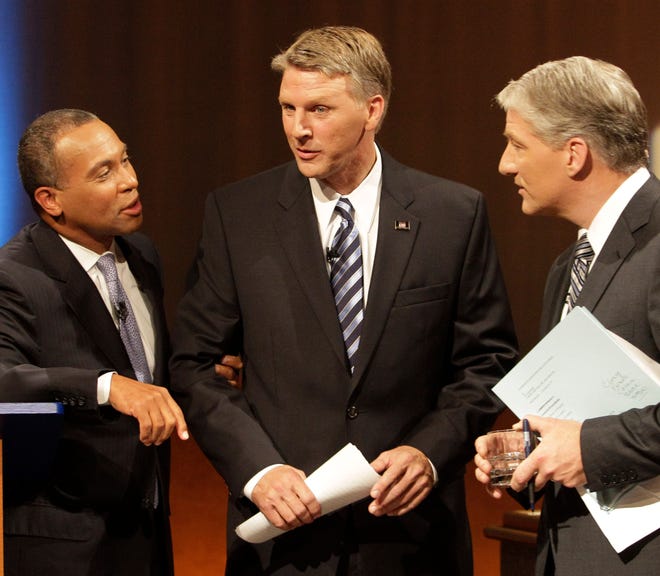 Incumbent Democrat Deval Patrick holds the arm of independent Timothy Cahill as they talk to CNN journalist and moderator John King after a gubernatorial debate at WGBH-TV in Boston, Tuesday night, Sept. 21, 2010. (AP Photo/Stephan Savoia)