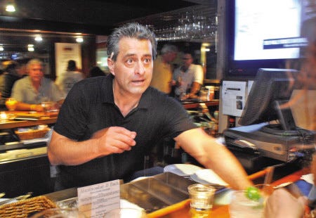 Lenny Willis, who was a bartender at Abercrombie and Finch 29 years ago, serves up drinks at a customer appreciation night on Wednesday.

Ralph Morang photo