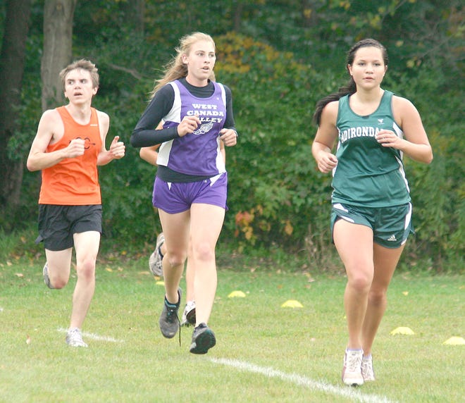 West Canada Valley Indian Stacey Hensley runs in a pack with runners from Cooperstown and Adirondack during Wednesday's meet on her home course.