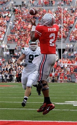 Ohio State's Terrelle Pryor catches a touchdown pass as Eastern Michigan's Brad Ohrman defends during the third quarter of Saturday's game. Ohio State won 73-20.