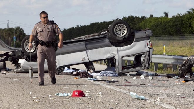 A crash stops traffic in the northbound lane of Florida's Turnpike on Sunday afternoon just north of the Glades Road exit.