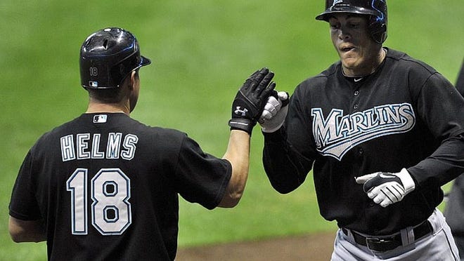 Wes Helms (18) congratulates Mike Stanton after Stanton's solo home run during the Marlins' win Sept. 25, 2010, in Milwaukee.