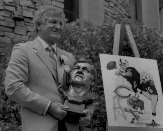 George Blanda holds his bust after his enshrinement into the Pro Football Hall of Fame in 1981.