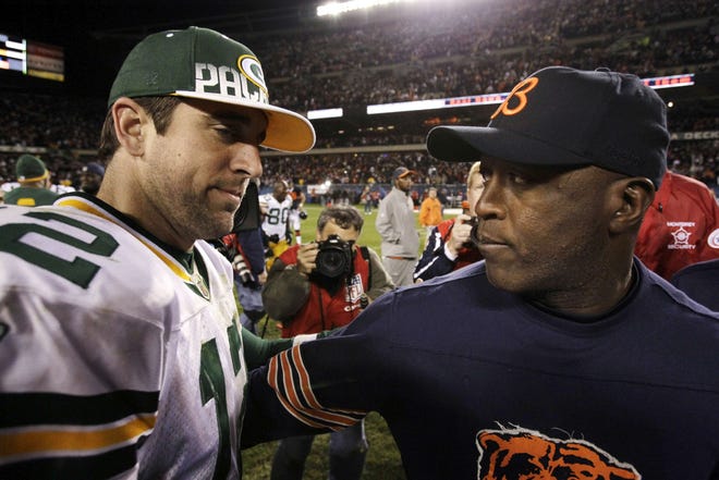 Chicago Bears coach Lovie Smith consoles Green Bay Packers quarterback Aaron Rodgers after the Bears' 20-17 win Monday, Sept. 27, 2010, in Chicago.