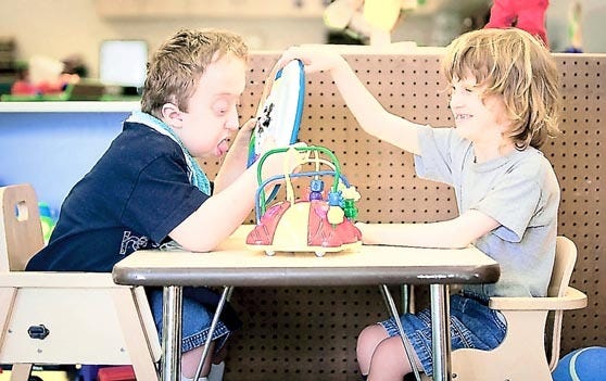 William Thompson (left) and classmate Michael Severns have some time together to learn a lesson in sharing as the two play toys at The Webster School Sept. 13. Thompson, 6, recently started at the school after delays due to his condition with Pfieffer Syndrome. By JON M. FLETCHER, Morris News Service