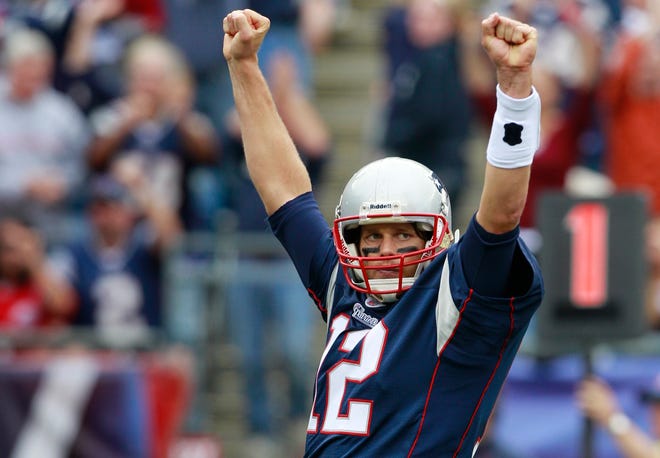 Patriots quarterback Tom Brady celebrates a touchdown by running back BenJarvus Green-Ellis during the fourth quarter of Sunday's game against the Bills in Foxboro.