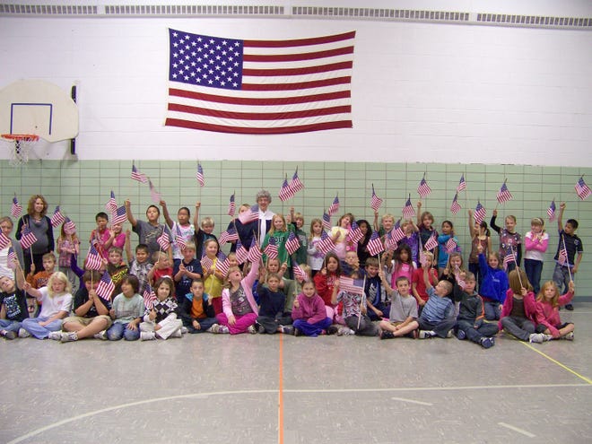 Prairie View Third Grade students and Betsy Ross (Judy Twete) with the flags donated by Prudential Financial, Inc.