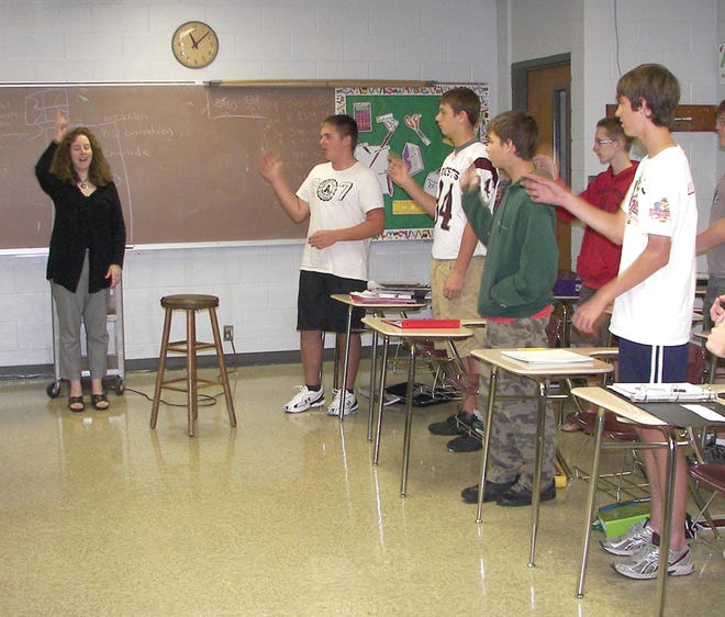 Preparing for visitors: Illinois Valley Central High School German teacher Andrea Bredeman, left, leads her German I class in song and dance. Bredeman, an IVC alumna, decided to become a German teacher after participating in the IVC-MvL exchange program her junior year of high school.