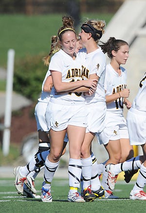 Courtney Pomeroy, center, is greeted after scoring one of her two goals during Adrian College's 2-0 victory over Hope in Wednesday's Michigan Intercollegiate Athletic Association opener.