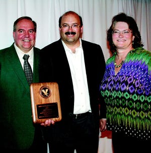 Marty Boscolo, flanked by his wife, Dawn, and Greencastle-Antrim Chamber of Commerce executive director Joel Fridgen, received the Jamees P. Oliver Citizenship Award at the annual chamber banquet.