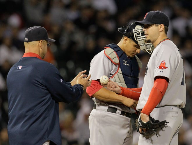 Boston Red Sox manager Terry Francona, left, relieves starting pitcher Josh Beckett as catcher Victor Martinez looks on during the seventh inning of a baseball game against the Chicago White Sox, Wednesday, Sept. 29, 2010.