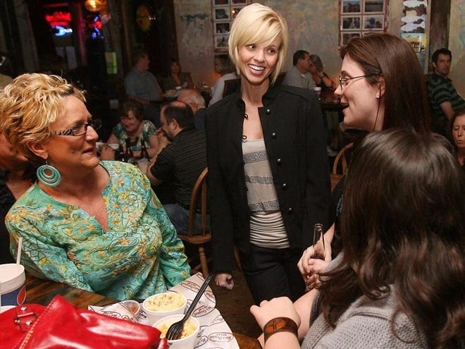 Julie Love-Templeton, a contestant on the television show “She's Got The Look,” talks to Nancy May, left, a co-worker and friend; Lisa Waldrop, a high school friend; and Jill Parsons, a friend and fan, during a viewing party of the show's season finale at Moe's Original Bar B Que on Wednesday. Templeton finished in the top three.