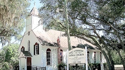 St. Ambrose Church is nestled under a canopy of large oak trees. By LORRAINE THOMPSON, Special to The Record