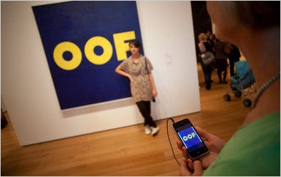 A British couple tour the Museum of Modern Art with the help of the MoMA app, which they downloaded from London.