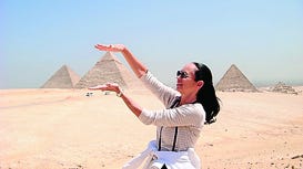 Anita Sanci does yoga poses at the pyramids.