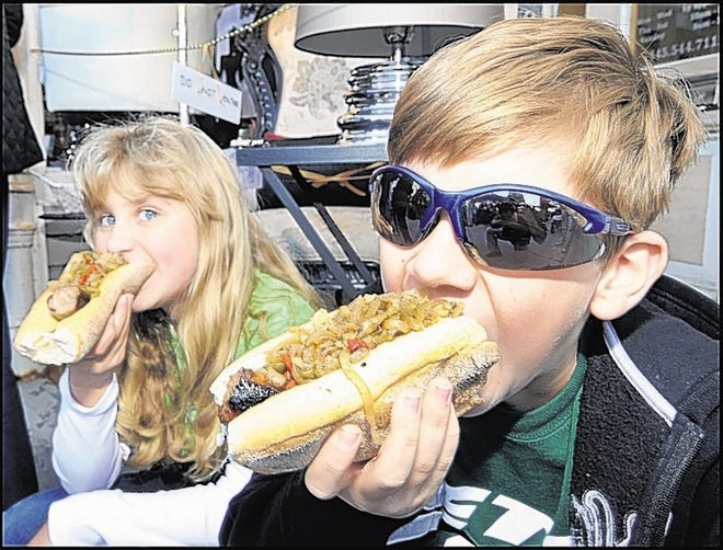 Rebecca Olenick, 8, and Matthew Olenick, 11, of Commack, tackle sausage sandwiches at the annual event, which features crafts, food, music and plenty of fun.