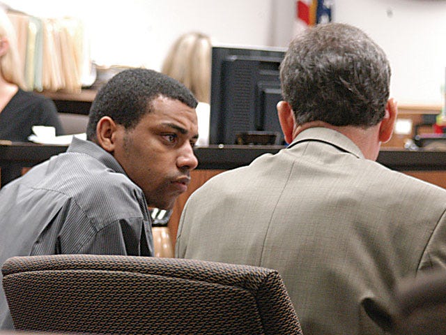 Davon Johnson confers with his attorney, Paul Henderson, at the Barstow Courthouse on Monday afternoon. Johnson is charged with torturing his infant son to death.